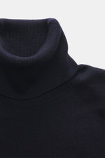 Close-up front top view of Ami Paris Merino Turtle Neck Sweater Navy showing narrow turtle neck, fine knit, and ribbed cuffs.