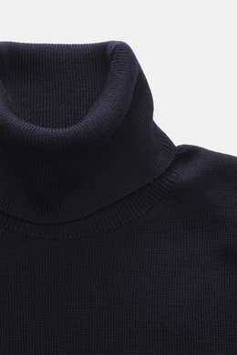 Close-up front top view of Ami Paris Merino Turtle Neck Sweater Navy showing narrow turtle neck, fine knit, and ribbed cuffs.