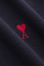 Close-up front view of Ami Paris Merino Turtle Neck Sweater Navy showing fine knit, soft merino wool, and red chest logo stitching.