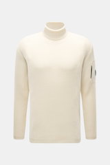 Front view of C.P. Company Turtleneck sweater cream, knit from virgin wool and microfiber, slim fit with soft feel, medium-fine knit, rib stitch, close turtleneck, zippered upper arm pocket, lens detail, and flexible rib cuffs.