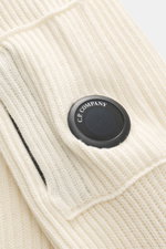 Close-up front view of C.P. Company Turtleneck sweater cream, knit from virgin wool and microfiber, soft feel, medium-fine knit with rib stitch, slim fit, close-fitting turtleneck, zippered upper arm pocket, label-typical lens detail, flexible rib cuffs.