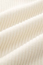 Close-up of the cream-colored C.P. Company Turtleneck sweater knit from virgin wool and microfiber, showing soft, medium-fine knit pattern and rib stitch.