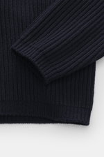 Close-up front view of C.P. Company Turtleneck sweater navy, knit from virgin wool and high-quality microfiber, soft feel, medium-fine knit with distinctive rib stitch pattern, slim fit with close-fitting turtleneck, zippered pocket on upper arm, label-ty