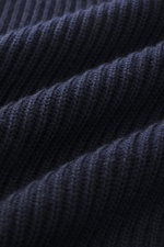 Close-up, detailed view of C.P. Company Turtleneck sweater navy showing medium-fine knit pattern, soft virgin wool and microfiber, distinctive rib stitch, slim fit with flexible rib cuffs.