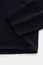 Close-up top-down view of navy Kiefermann Merino Fine Knit Sweater 'Malt' showing pure merino wool, super soft touch, very fine knit pattern, slim fit, high crew neckline, and elastic sleeve cuffs.