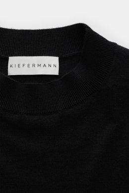 Close-up front view of the Kiefermann Merino fine knit sweater 'Malt' black, showing pure merino wool, super soft touch, very fine knit pattern, slim fit, high crew neckline, and elastic sleeve cuffs.