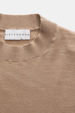 Close-up front view of Kiefermann Merino Fine Knit Sweater 'Malt' light brown showing high crew neckline, pure merino wool, super soft touch, very fine knit pattern, slim fit, and elastic sleeve cuffs.