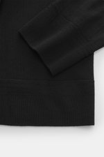 Close-up front view of Barena Venezia Merino Fine Knit Turtleneck Sweater Black, showing fine knit of soft merino wool, soft touch, very fine knit pattern, extra slim fit, fitted turtleneck, and decorative knit trim on the cuff.