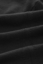 Close-up perspective of the fine knit fabric of the Barena Venezia Merino Fine Knit Turtleneck Sweater Black, showing soft touch, very fine knit pattern, extra slim fit, fitted turtleneck, and decorative knit trim on the cuff made of soft merino wool.