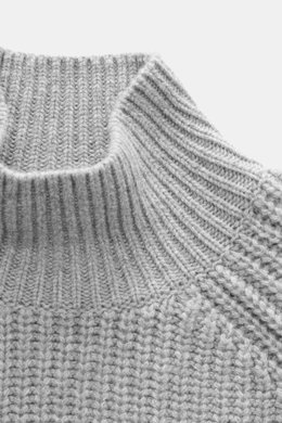 Nahaufnahme des Allude Mock Neck Pullovers grau meliert mit Stehkragen, mittelgrobem Patent-Strick, Raglan-Ärmeln, Rippbündchen, Regular Fit, weicher Wolle-Cashmere-Mix.