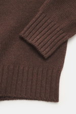 Close-up top view of the Bruno Manetti Cashmere turtleneck jumper dark brown sleeve and ribbed cuff showing medium-fine knit texture, soft feel, and comfortable ribbed bands.