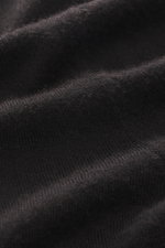 Close-up front view of FTC Fine knit turtleneck sweater dark brown showing blend of Fair-Trade Cashmere and Lyocell (SeaCell), soft touch, very fine knit pattern, slim fit, fitted turtleneck, and comfortable ribbed cuffs.