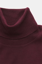 Nahaufnahme eines von oben fotografierten von Braun Merino Feinstrick-Rollkragenpullovers bordeaux, Slim Fit, reiner Merinowolle, weicher Griff, feines Strickbild, anliegender Rollkragen, flexible Rippbündchen.
