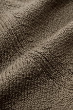 Close-up texture shot of Fioroni Crew neck jumper olive, showcasing medium-fine knit pure cotton fabric from a top-down perspective.