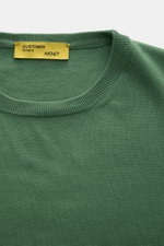 Close-up top view of B.F. Knitwear Crew neck jumper green, a slim fit pure cotton jumper with fine knit and ribbed bands.

Description: 
<p>A versatile essential for spring: This crew neck jumper in pure cotton by B.F. KNITWEAR enhances any wardrobe with 