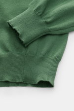 Close-up top-down view of B.F. Knitwear Crew neck jumper green showing fine knit, ribbed bands, and soft pure cotton fabric.
