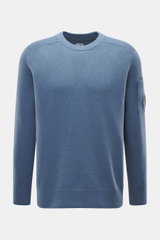 Front view of C.P. Company Crew neck sweater grey blue, a medium fine knit wool and microfiber blend with raglan sleeves, ribbed cuffs, and a zipped sleeve pocket featuring the brand's lens detail.

Description: 
<p>Timeless casual favorite: The knit swea