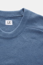 C.P. Company Crew neck sweater grey blue shown from a close-up top-front perspective, highlighting the medium fine knit, crew neckline, and raglan sleeve stitching. 

<p>Timeless casual favorite: The knit sweater from C.P. COMPANY combines pleasant warmth