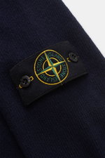 Close-up front detail of Stone Island Crew Neck Sweater 'Lambswool' navy showing the iconic compass badge on the upper arm.

Description: <p>Stylish essential for the cold season: This casual sweater by STONE ISLAND made of a warm wool blend impresses wit