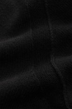 Close-up front view of Stone Island Crew Neck Sweater 'Lambswool' Black showing medium-fine knit texture, distinctive link-knit details, soft virgin wool and microfiber blend, contrasting knitted stripes, and ribbed cuffs; features crew neckline and iconi