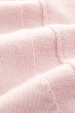 Close-up front view of the Stone Island Crew Neck Sweater 'Lambswool' rose, showing soft, medium-fine link-knit wool texture and ribbed cuffs. 

Description: Stylish essential for the cold season: This casual sweater by STONE ISLAND made of a warm wool bl