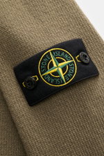 Close-up front view of the Stone Island Crew Neck Sweater 'Lambswool' grey green, showing its distinctive compass badge on the sleeve. Stylish essential for the cold season: This casual sweater by STONE ISLAND made of a warm wool blend impresses with dist