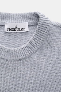 Stone Island Crew Neck Sweater 'Lambswool' smoky blue shown from above, featuring a ribbed crew neckline and knit texture. Stylish essential for the cold season: This casual sweater by STONE ISLAND made of a warm wool blend impresses with distinctive link