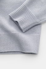 Close-up view of the Stone Island Crew Neck Sweater 'Lambswool' smoky blue sleeve and cuff, knit from virgin wool and microfiber with a soft touch.

Description: <p>Stylish essential for the cold season: This casual sweater by STONE ISLAND made of a warm 