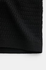 Close-up of the textured fine knit of the Emporio Armani Short sleeve jumper black, photographed from a top-down perspective.

Description:  
<p>Versatile companion: This lightweight short sleeve jumper in pure virgin wool by EMPORIO ARMANI has a subtle t