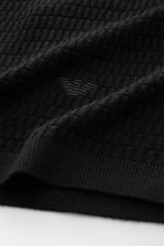 Close-up front view of Emporio Armani Short sleeve jumper black showing fine textured knit, ribbed bands, and logo stitching on hem.