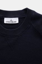 Stone Island Crew Neck Sweater Navy shown in close-up from above, highlighting the fine knit pattern, crew neckline, and soft texture. Warming comfort with iconic character: This STONE ISLAND sweater combines a high-quality wool blend with sporty style. R
