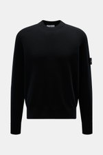 Stone Island Black crew neck sweater shown from the front, featuring raglan sleeves, ribbed cuffs, and the brand's compass badge on the upper arm. Warming comfort with iconic character: This STONE ISLAND sweater combines a high-quality wool blend with spo