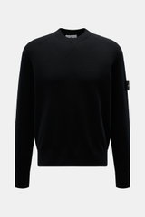 Stone Island Black crew neck sweater shown from the front, featuring raglan sleeves, ribbed cuffs, and the brand's compass badge on the upper arm. Warming comfort with iconic character: This STONE ISLAND sweater combines a high-quality wool blend with spo