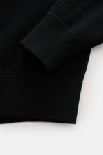 Close-up view of the Stone Island Black crew neck sweater's ribbed cuff and fine knit pattern, showing soft virgin wool fabric.

Description: <p>Warming comfort with iconic character: This STONE ISLAND sweater combines a high-quality wool blend with sport