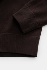 Close-up angled view of Stone Island Dark Brown Crew Neck Sweater showing ribbed cuff, elastic knit, and fine wool blend texture.

<p>Warming comfort with iconic character: This STONE ISLAND sweater combines a premium wool blend with a sporty aesthetic. R