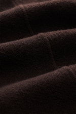 Close-up, macro side view of the Stone Island Dark Brown Crew Neck Sweater fabric showing fine knit texture and soft wool blend material.