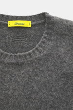 Close-up top view of Drumohr Crew neck sweater navy in soft lambswool, featuring fine knit pattern, crew neckline, and ribbed cuffs.