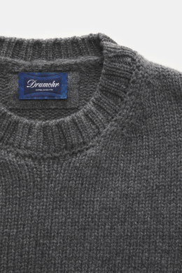 Close-up front view of Drumohr Cashmere crew neck jumper dark grey showing chunky knit texture, rib-knit cuffs, and label.

Description: <p>Stay comfortably warm through the autumn/winter season with this ultra-soft crew neck sweater made from chunky cash