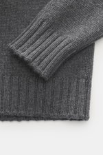 Close-up from above of Drumohr Cashmere crew neck jumper dark grey showing chunky knit texture and flexible rib-knit cuffs.

Description: <p>Stay comfortably warm through the autumn/winter season with this ultra-soft crew neck sweater made from chunky cas