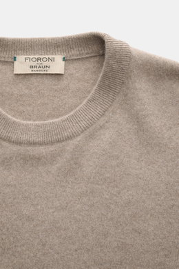 Close-up front view of Fioroni Cashmere Crewneck Sweater beige melange showing crew neckline, pure baby cashmere, very soft feel, fine knit pattern, slim fit, and flexible ribbed cuffs.
