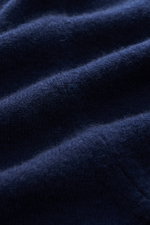 Fioroni Cashmere Crewneck Sweater dark blue fabric close-up from a side angle showing pure baby cashmere, very soft feel, fine knit, slim fit, crew neckline, flexible ribbed cuffs.
