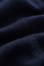 Close-up image of the Fioroni Cashmere Crew Neck Sweater 'Duvet' Navy fabric, photographed from a side angle showing luxurious, fine knit texture and soft, dense pure cashmere fibers with flexible ribbed cuffs, slim fit, and crew neckline. Luxurious warmt