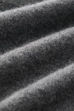Close-up angled view of the Fioroni Cashmere Crew Neck Sweater 'Duvet' Dark Grey Melange showing fine knit texture and soft cashmere fibers, highlighting luxurious warmth with Italian craftsmanship, pure cashmere, very soft touch, slim fit, crew neckline,