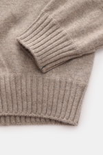 Close-up from above of Fioroni Cashmere Crew Neck Sweater 'Duvet' Taupe Melange showing fine knit texture, ribbed cuffs, and slim fit, made of pure cashmere with a very soft touch.