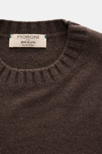 Close-up top view of Fioroni Cashmere Crew Neck Sweater 'Duvet' Dark Brown Melange, showing pure cashmere, fine knit, slim fit, crew neckline, and ribbed cuffs. Luxurious warmth with Italian craftsmanship, very soft touch, finished with Lake Trasimeno wat