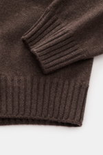 Close-up top-down view of Fioroni Cashmere Crew Neck Sweater 'Duvet' Dark Brown Melange showing ribbed cuffs and fine knit texture, pure cashmere, very soft touch, slim fit, crew neckline, flexible ribbed cuffs.