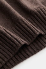 Close-up top view of the ribbed cuffs on the Fioroni Cashmere Crew Neck Sweater 'Duvet' Dark Brown Melange, showcasing luxurious pure cashmere with a fine knit texture. Luxurious warmth with Italian craftsmanship: FIORONI's crew neck sweater is made from 