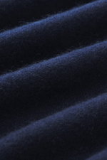 Close-up image showing the fine knit pattern and texture of navy fabric from the Gran Sasso Cashmere crew neck sweater navy, photographed from a macro perspective, highlighting pure cashmere, very soft feel, regular fit, crew neckline, and comfortable rib