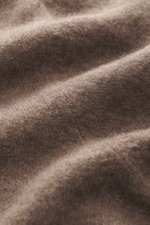 Close-up view of the Gran Sasso Cashmere crew neck sweater grey brown melange fabric showing pure cashmere, very soft touch, fine knit pattern, regular fit, crew neckline, and comfortable ribbed cuffs.
