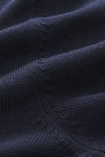 Close-up, top-down view of the Gran Sasso Crew neck sweater navy showing pure virgin wool with soft touch, medium-fine knit pattern, slim fit, crew neckline, and comfortable ribbed cuffs.